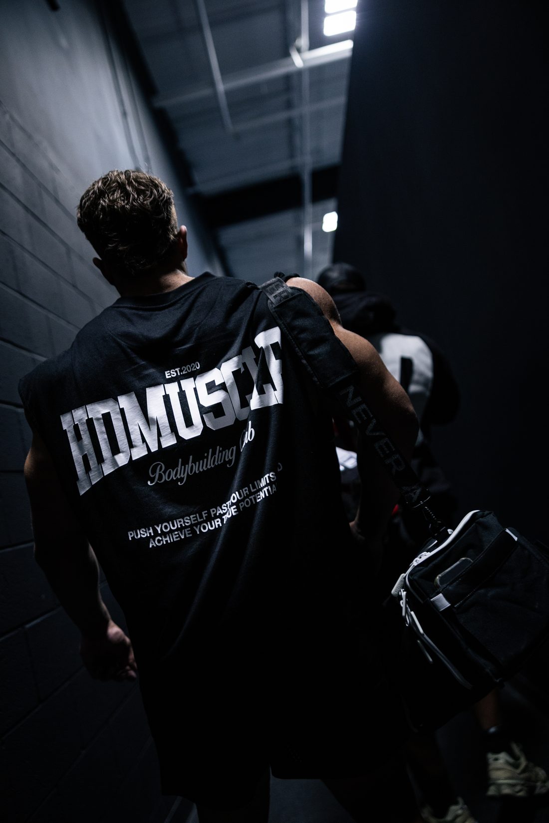Athlete walking through a tunnel toward the gym floor